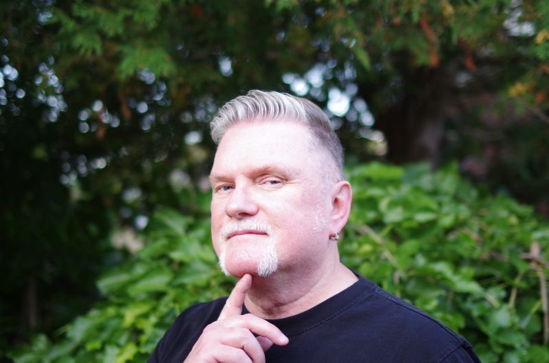 Portrait of David Moulton Counsellor for Toronto looking curious standing in front of a mulberry bush